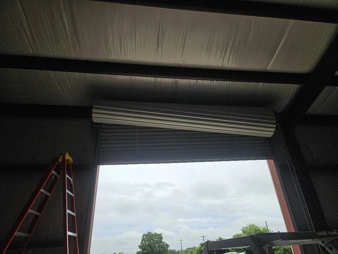 Roll-up door on a metal commercial building, seen from inside