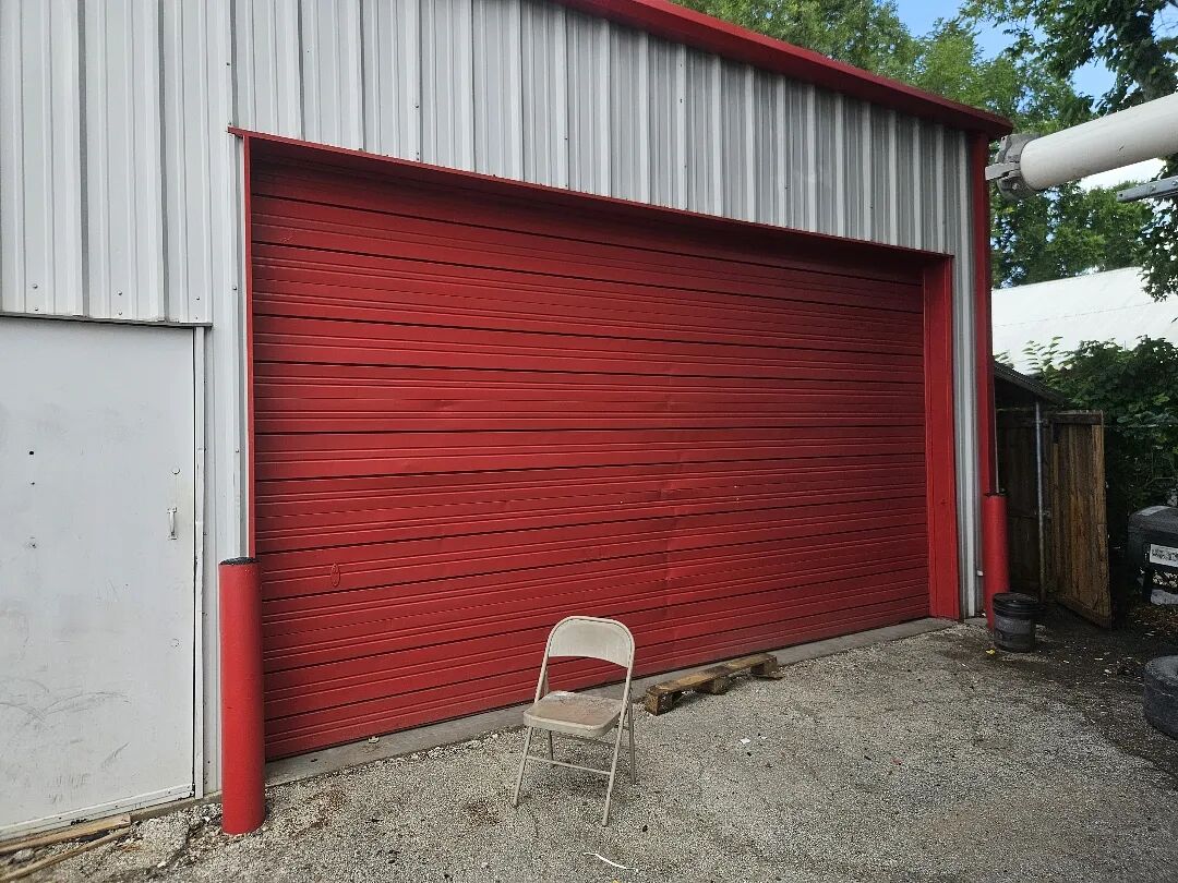 Red sectional overhead door on a metal commercial building