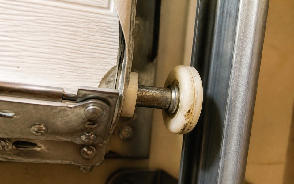 Worn garage door roller from a high-use College Station home