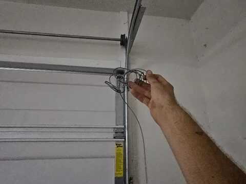 A frayed garage door lift cable