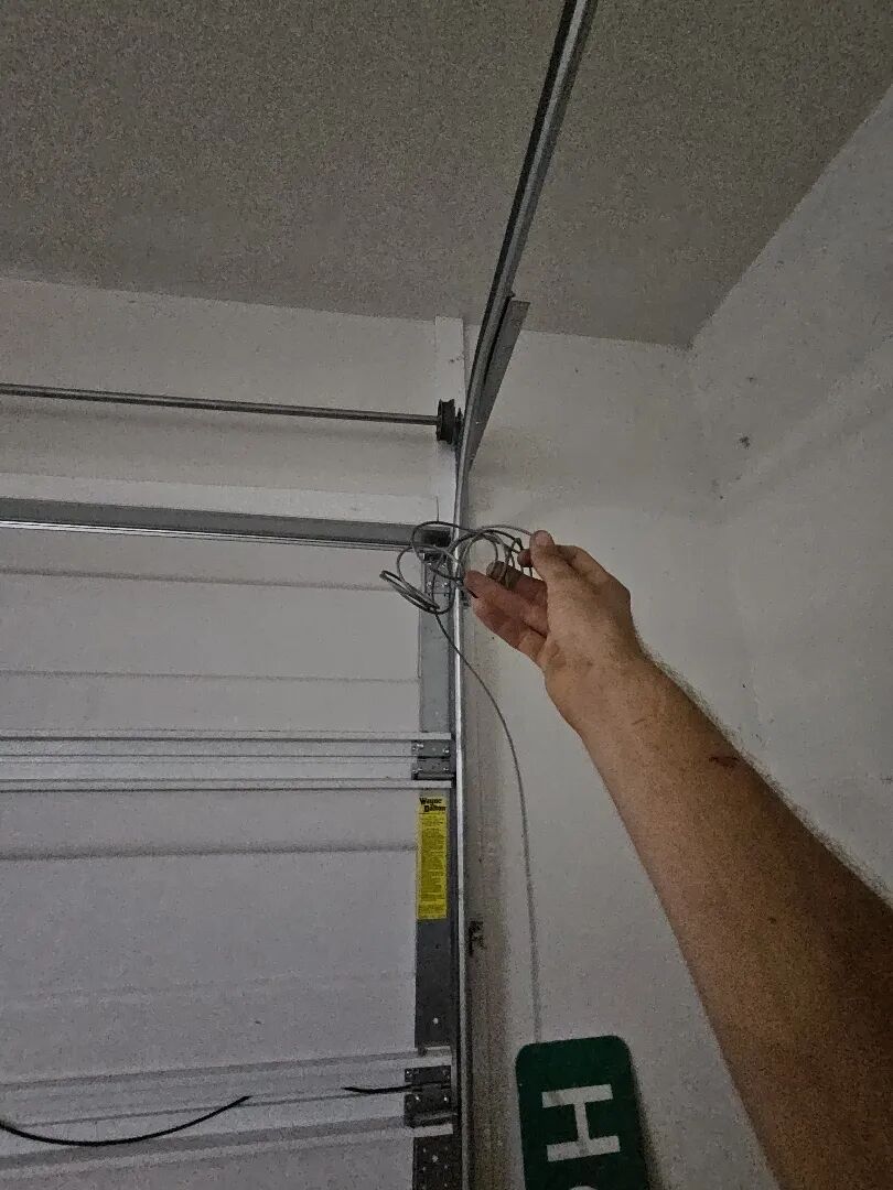 Snapped garage door lift cable at the top of the track