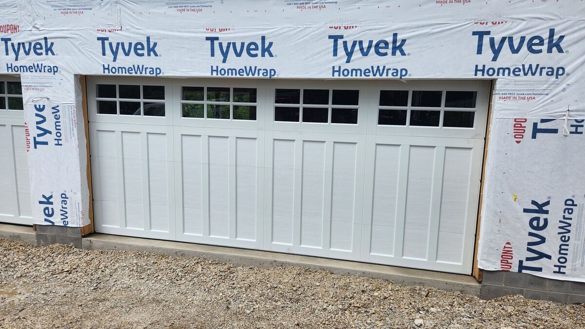 New white sectional garage door on a house under construction