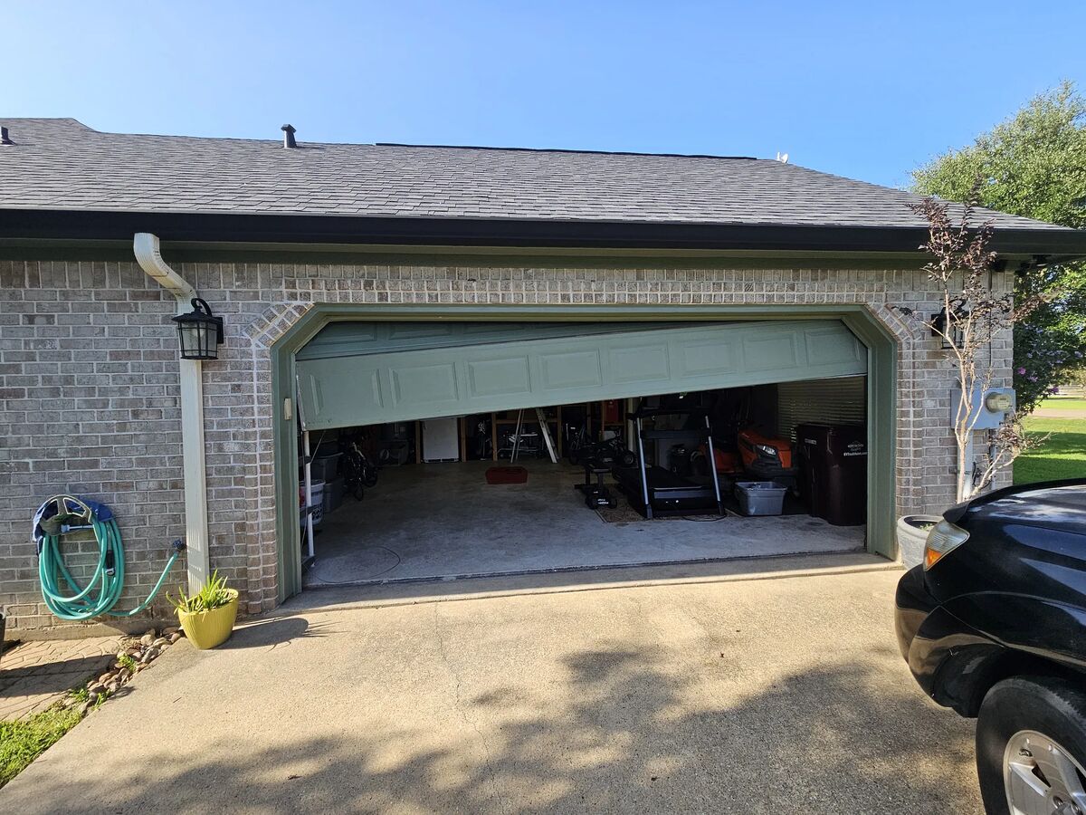 Double garage door hanging crooked and off track after a lift cable broke