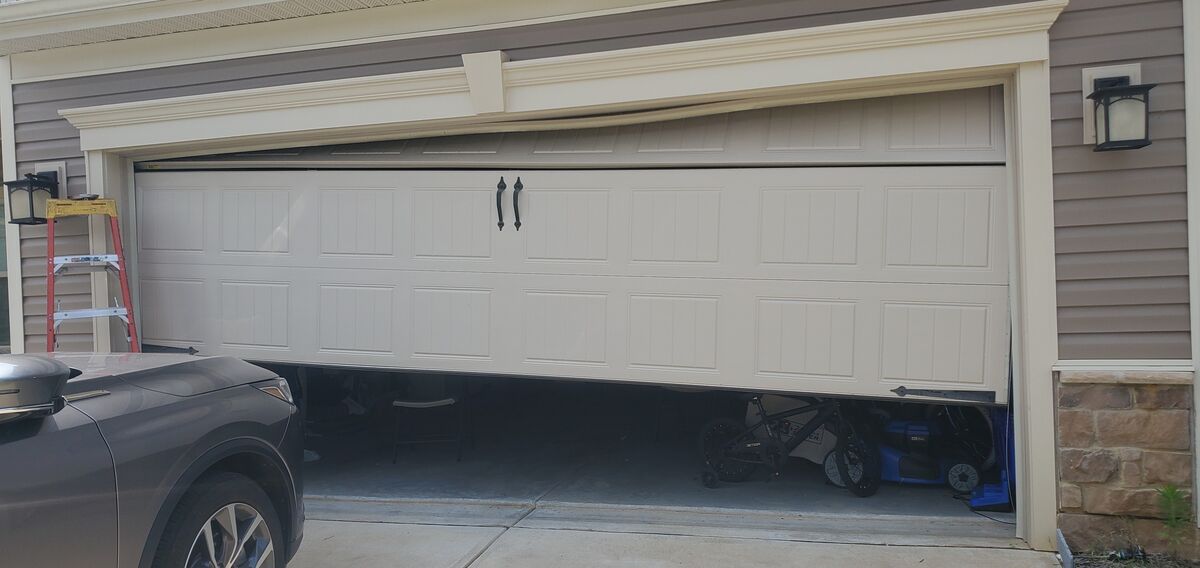 Garage door stuck crooked after coming off its track