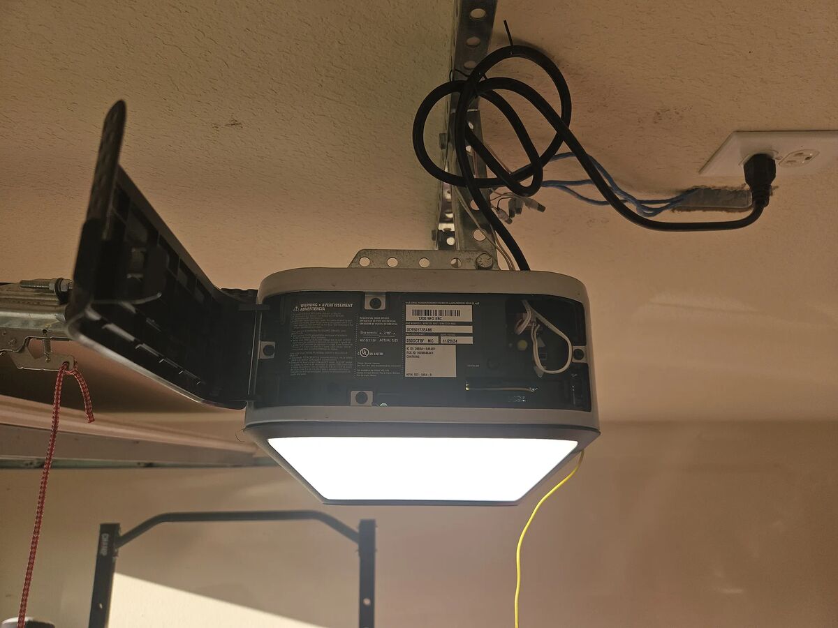 Garage door opener with an integrated light, installed on the garage ceiling