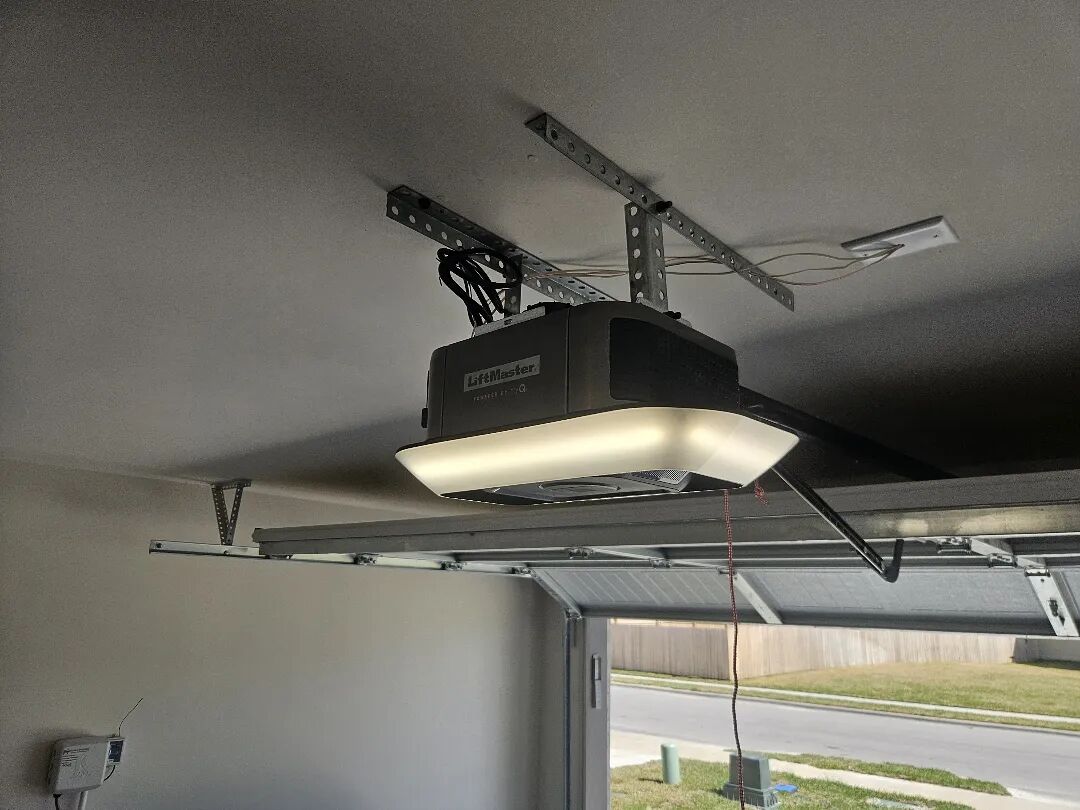 Garage door opener with a built-in light mounted to the garage ceiling