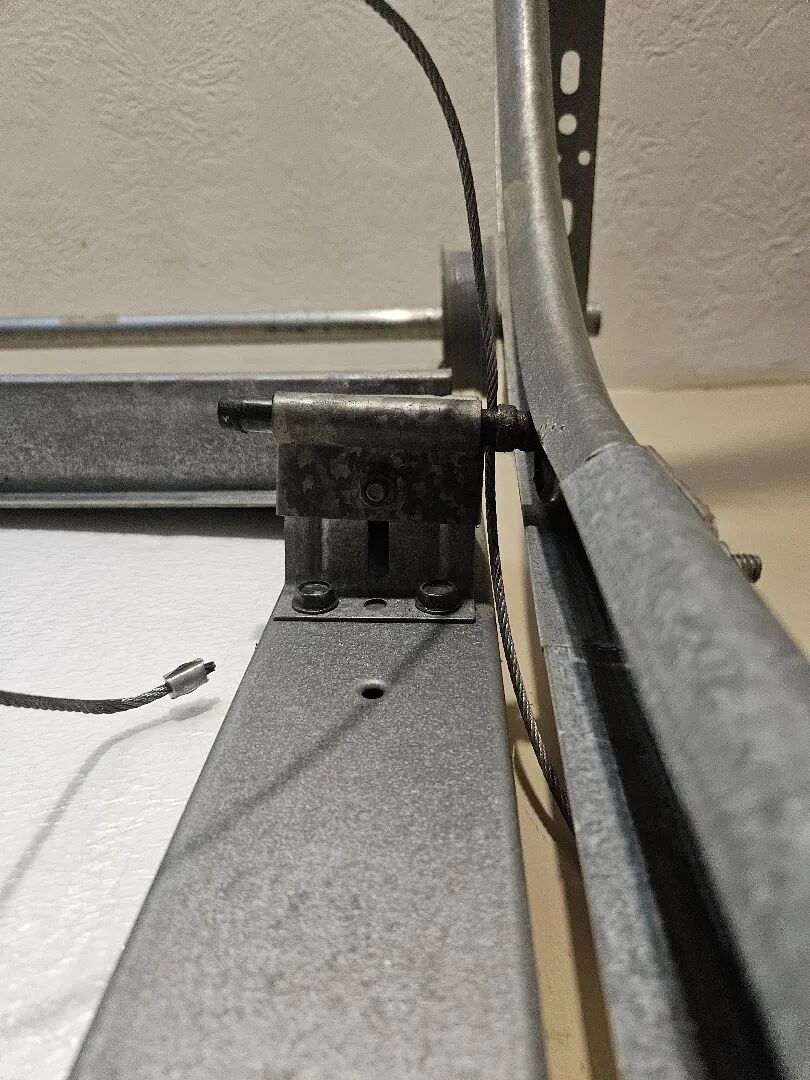 Garage door roller and hinge running in the track