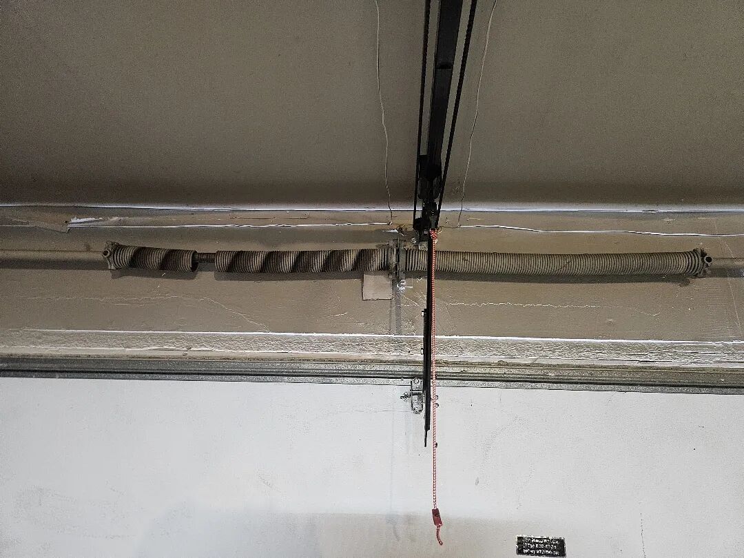 Broken torsion spring on the shaft above a garage door